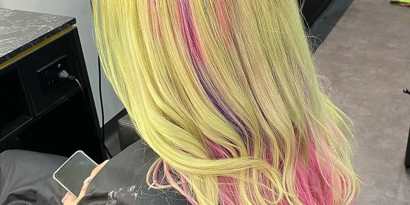 Long straight hair coloured pale yellow with purple and pink ribbon streaks through it