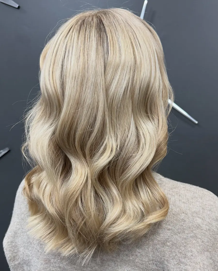 Shoulder-length creamy blonde hair finished in polished waves