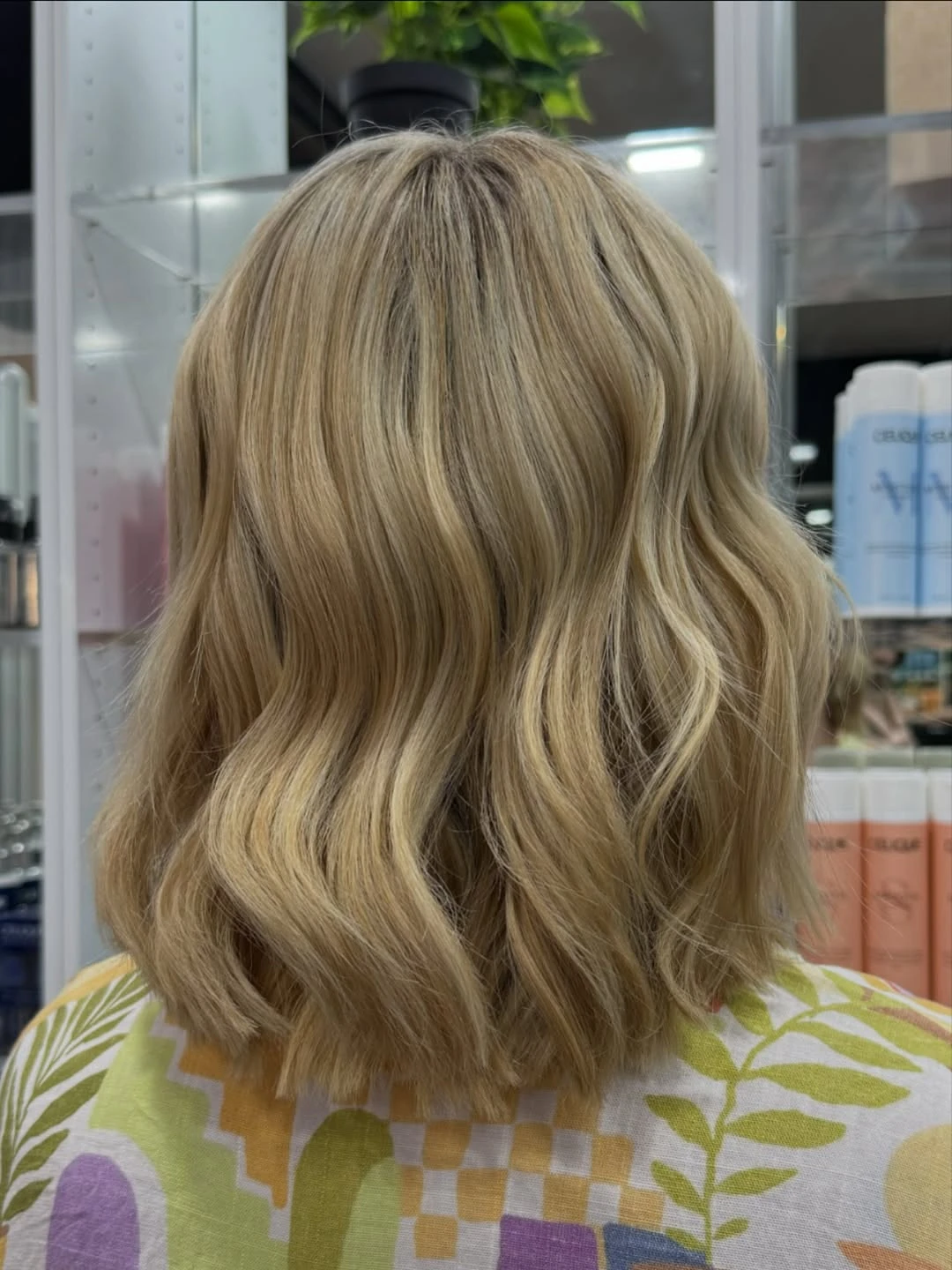 Mid-length warm blonde hair styled into loose waves