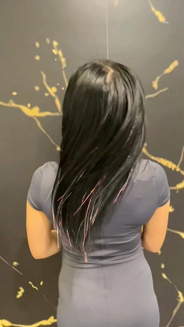 Long dark hair worn sleek and straight down the back