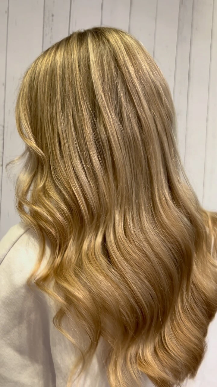 Long creamy blonde balayage waved through the lengths