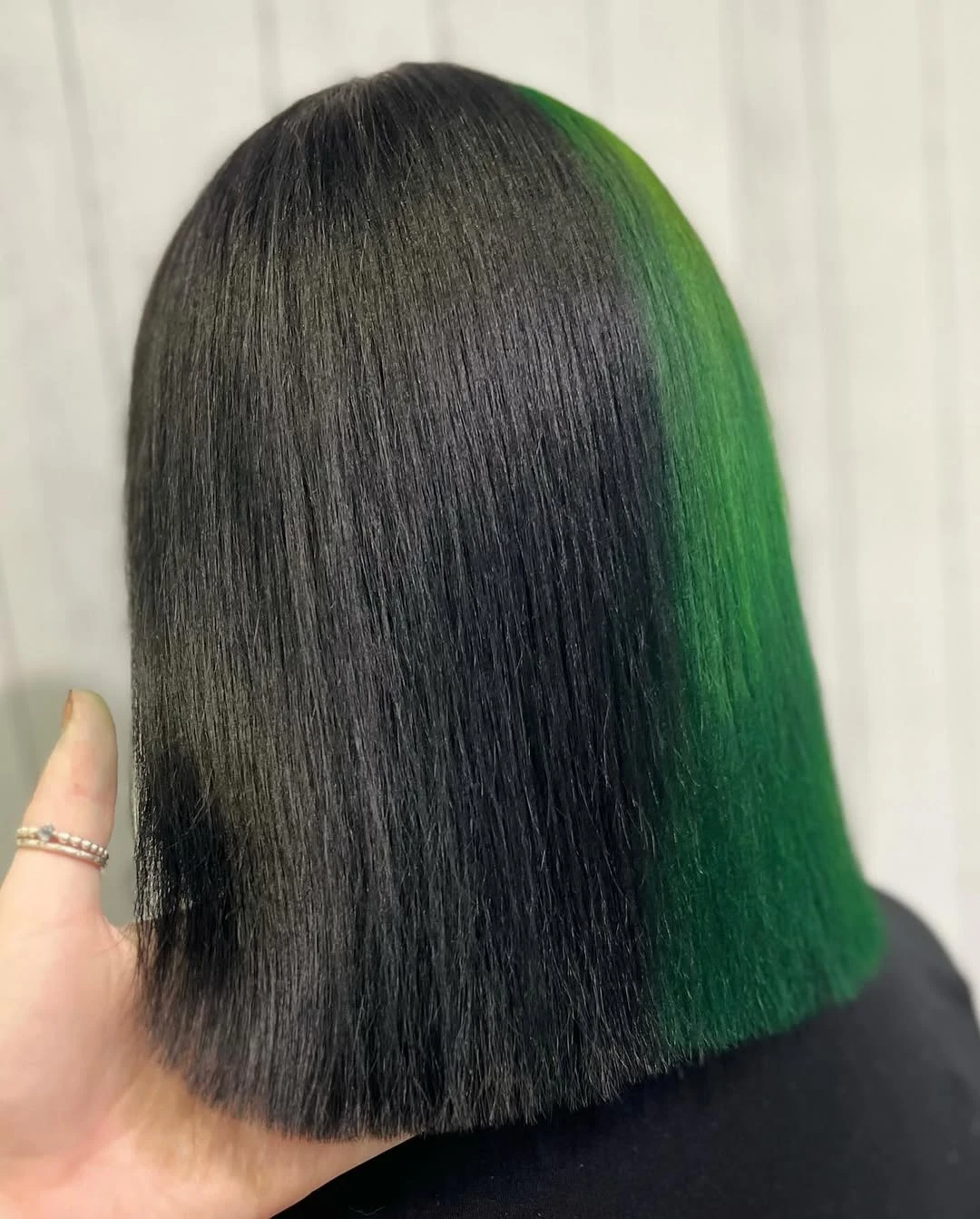 Sleek black bob with a bright green colour panel through one side