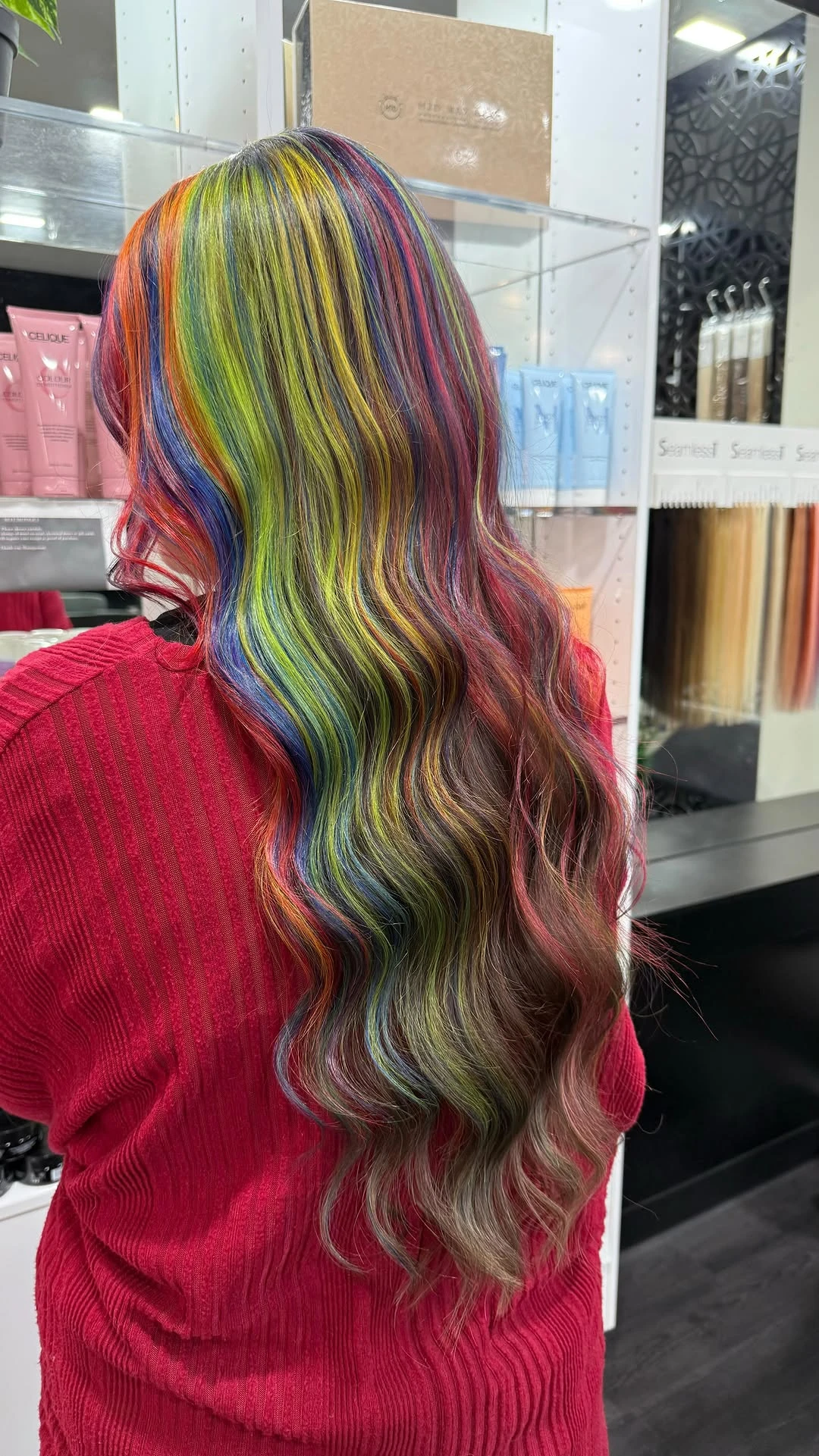 Long waved hair with a full rainbow-striped colour panel down one side